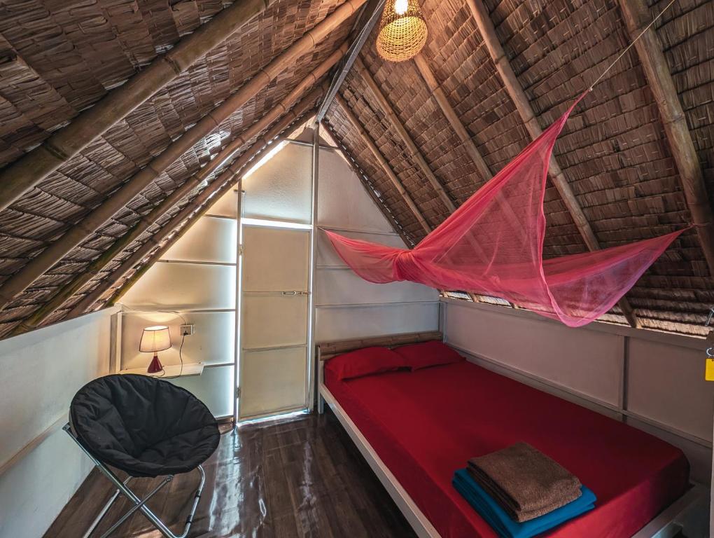 Inside a private bungalow with a bed and mosquito net