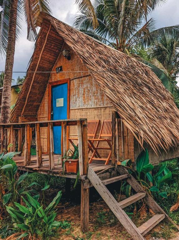 Thatched-roof bungalow among the palms