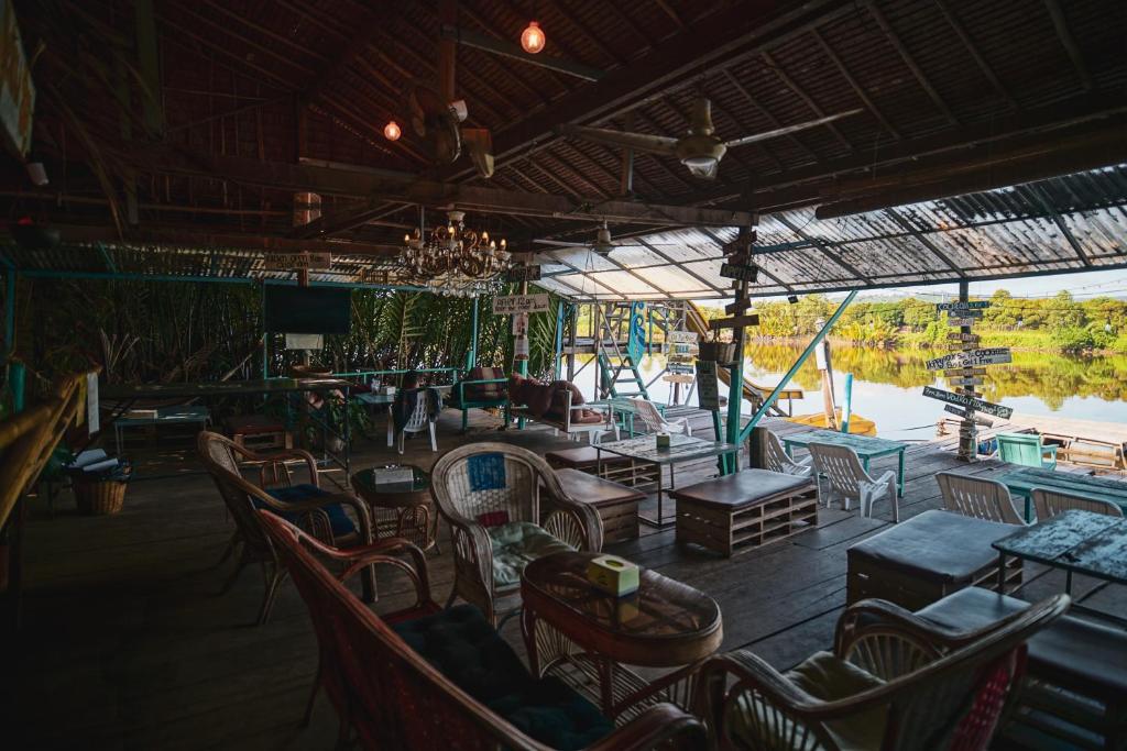 Open-air riverside lounge with rattan chairs